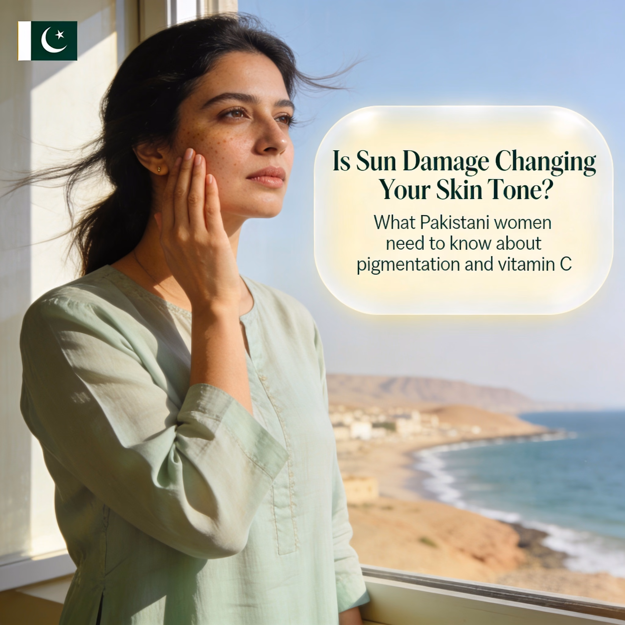 Pakistani woman with uneven skin tone near window overlooking Gwadar skyline, concerned about sun damage and pigmentation